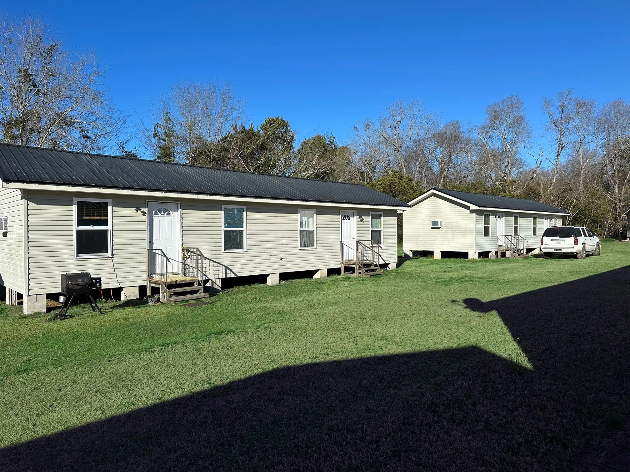 Cabins and open lawns under blue skies at Vogtle Ranch