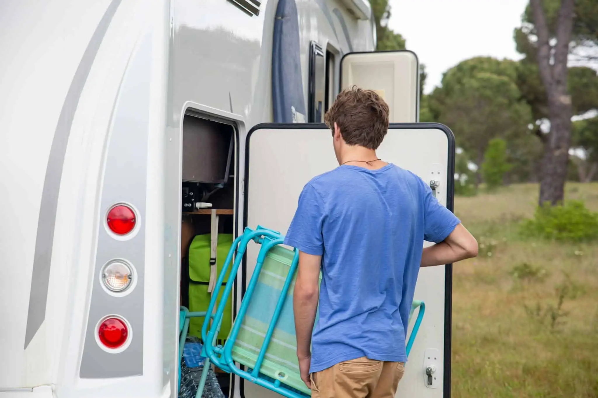 Camper preparing an RV for a stay in the lush green Georgia countryside